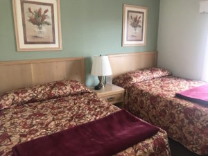 Two beds with red blankets
