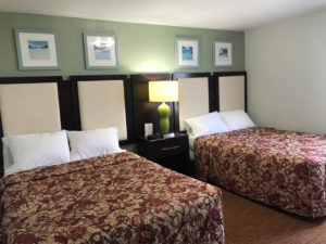 Two beds with padded headboards