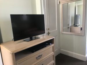 A mirror behind a TV