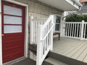 A porch beside a red door