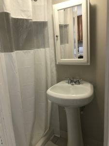A mirror above a white bathroom sink
